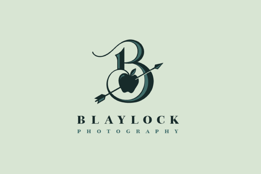 a dark turquoise apple at the center of an ornate letter b with an arrow piercing the apple diagonally. The log sits on a mint background with Blaylock Photgraphy arranged below in a serif typeface