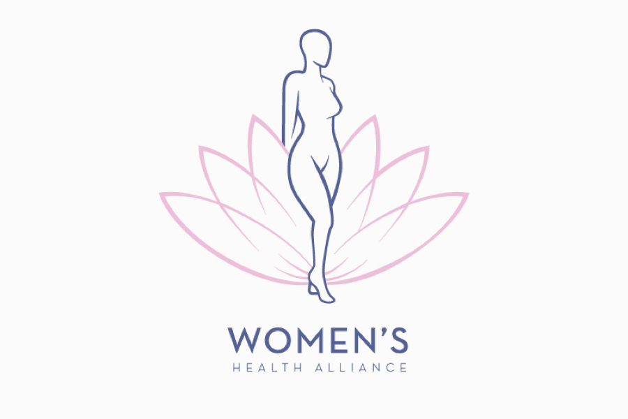An outlined female form is centered within a pink lotus shaped form. The words Women's Health Alliance appear below in a modern purple sans serif font.